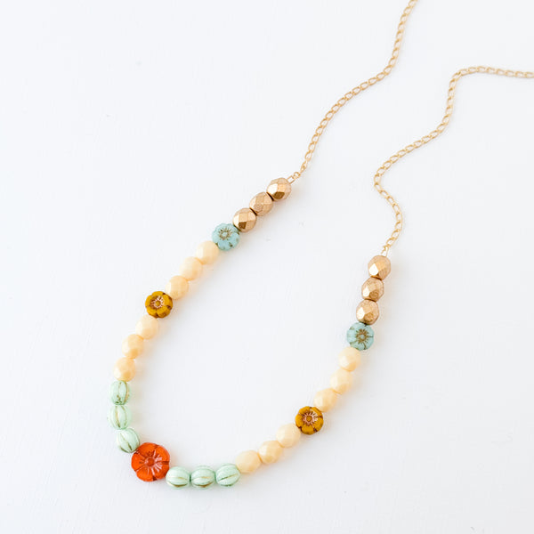 Elegant Cream and Gold Beaded Necklace with Floral Accent