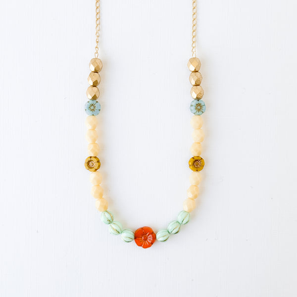 Elegant Cream and Gold Beaded Necklace with Floral Accent