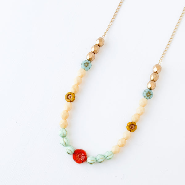 Elegant Cream and Gold Beaded Necklace with Floral Accent